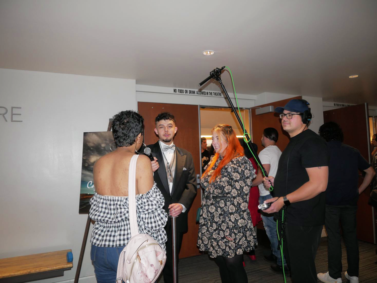 Students stop for interviews along the red carpet.