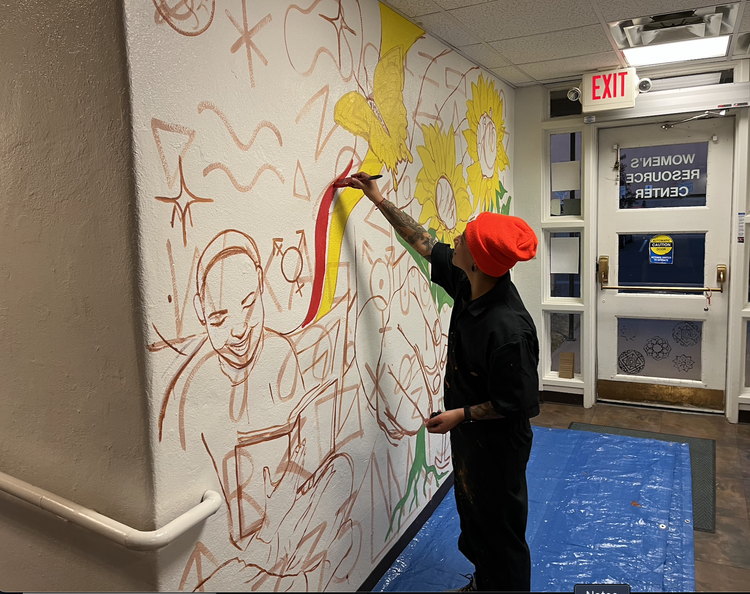 Cruz works on mural