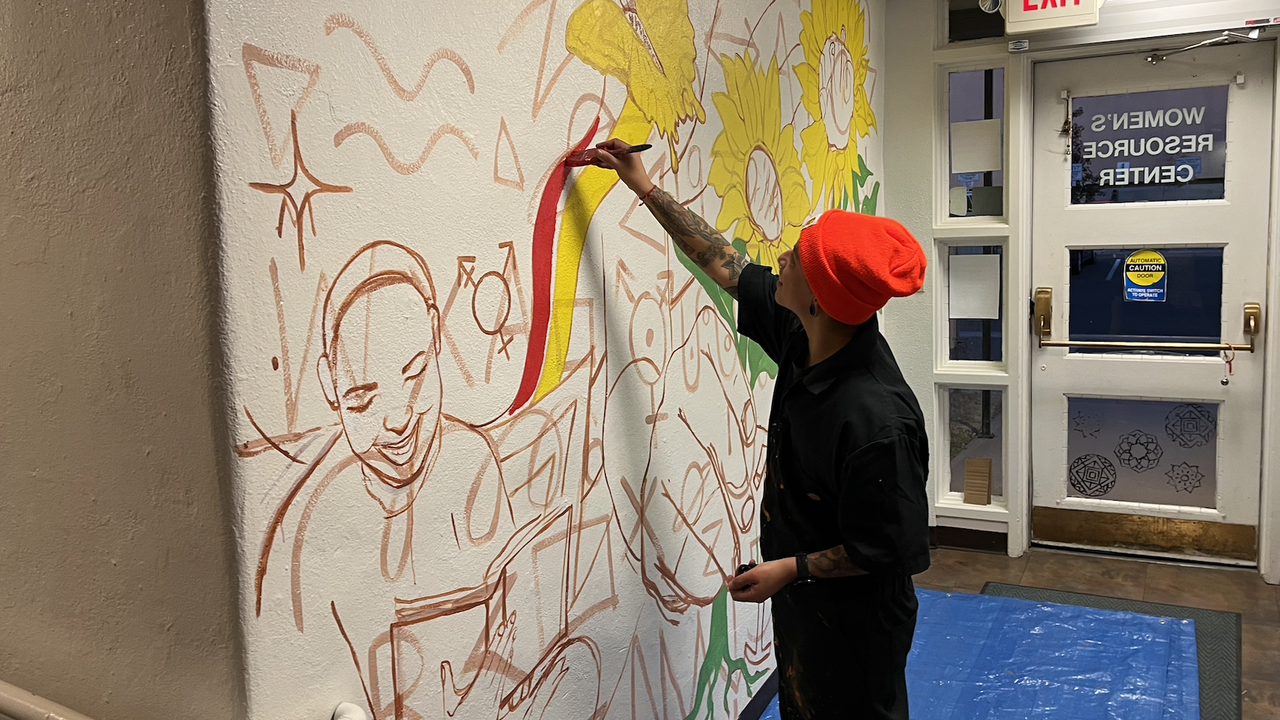 Cruz works on mural