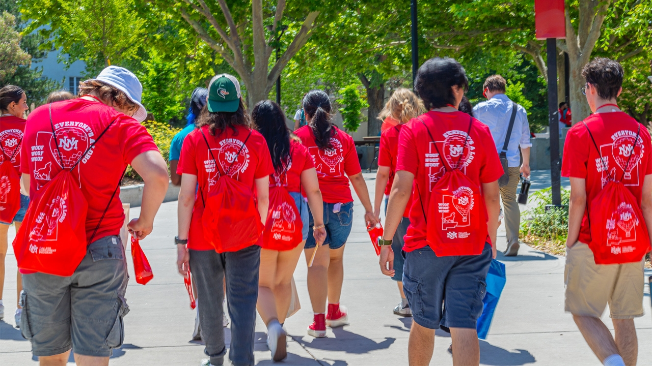 photo of students walking across UNM campus