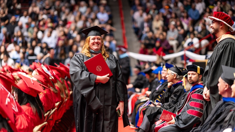 A graduate smiles 