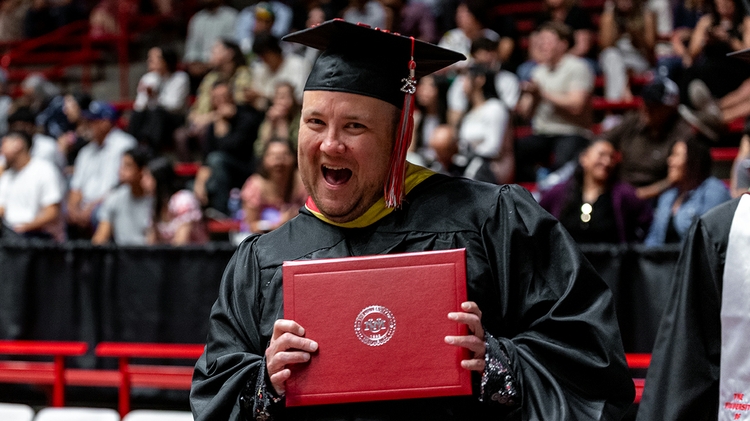 A graduate student celebrates