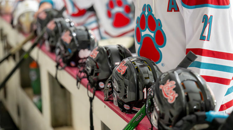 UNM helmets lined up on the bench prior to game