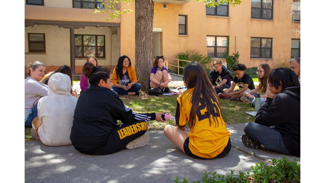 photo of students sitting in a circle