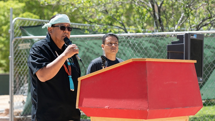 Warlance Chee (Diné), left, provides background before 