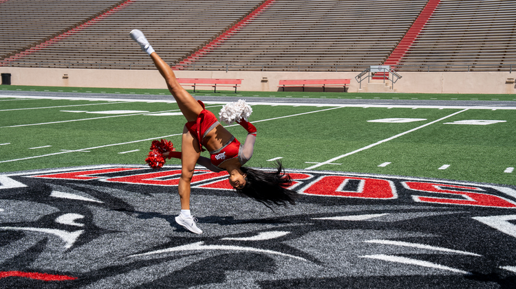 Malia Dumlao performing a dance move at University Stadium.