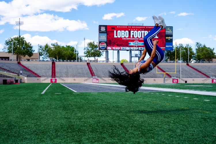 Malia Dumlao performs a back flip at University Stadium.