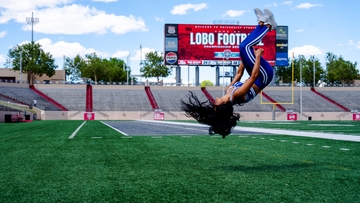 Malia Dumlao performs a back flip at University Stadium.