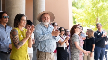 Attendees celebrate the ribbon cutting