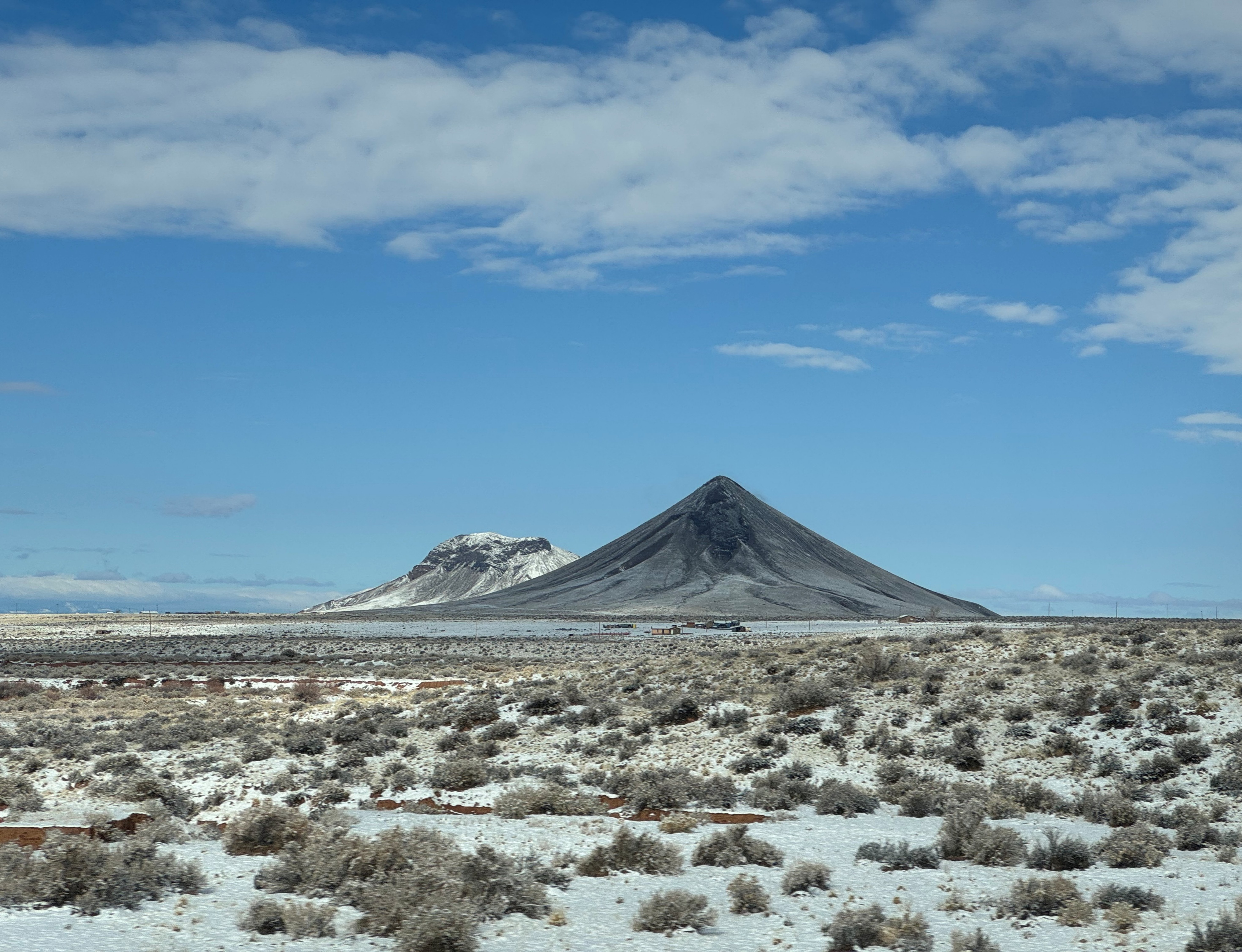 These 8-7 million-year-old Hopi Buttes volcanic necks in Arizona are manifestations of mantle convection and surface warping that influenced the pathway and tempo of proto-Colorado River evolution. Mantle-driven uplifts in the Rocky Mountains caused tilting of the Colorado Plateau to the southwest and the north-to-south development of the Colorado River between 8 and 4.8 million years ago; photo by Laura Crossey. These 8-7 million-year-old Hopi Buttes volcanic necks in Arizona