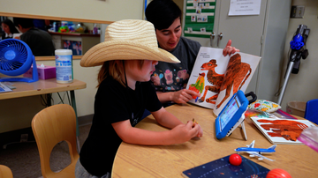 Speech pathalogist reading to a child