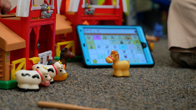 Child playing with farm animal toys