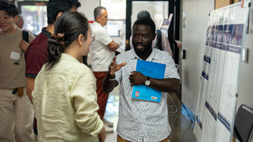 Showcasing economics research to an audience member.