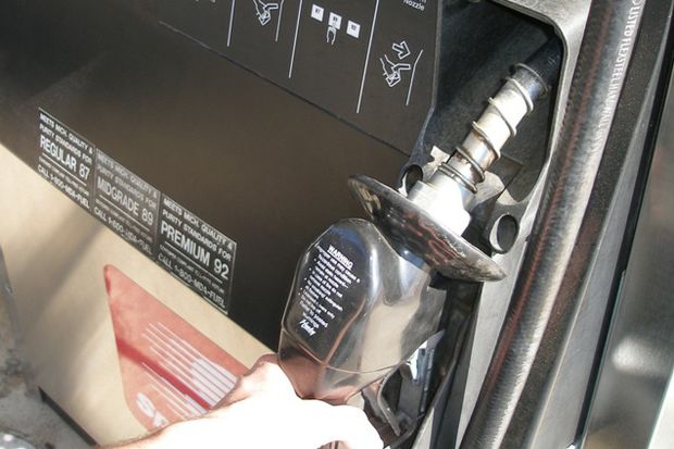 hand at gas pump