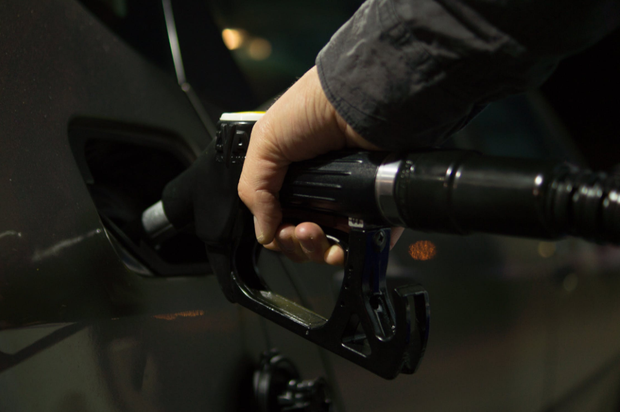 gas nozzle into car