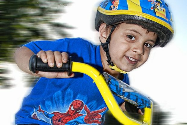 Boy riding new bike with helmet