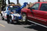 acsc tow truck and driver hitching up car