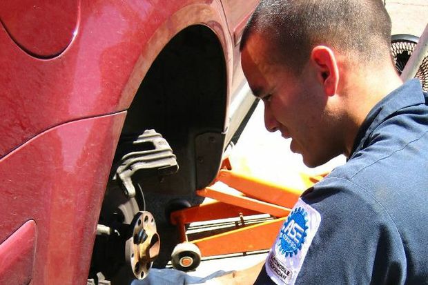 Mechanic repairing brakes