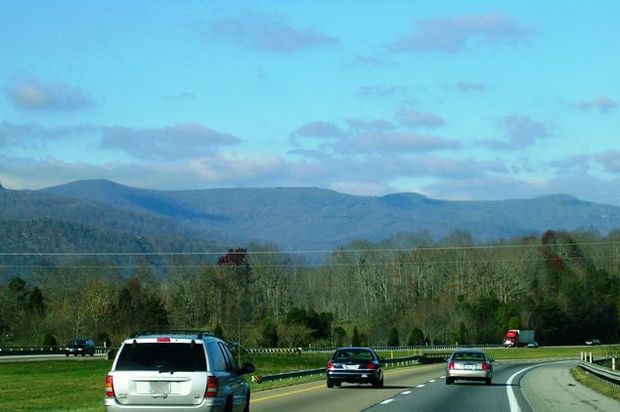 highway with mountains trees in background