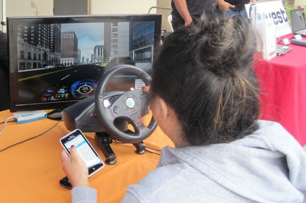 teen at distracted driving simulator