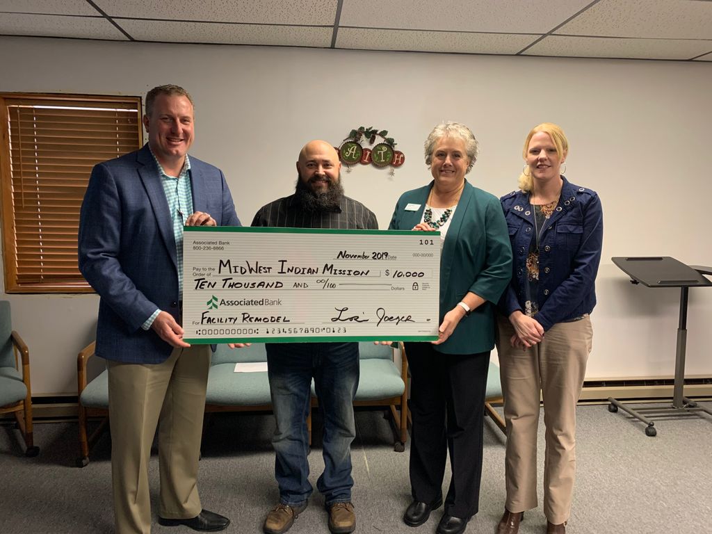 Associated Bank colleagues present a check to Midwest Indian Mission. Pictured from left to right: Brad Kowieski, Micah Dewing, Lori Jaeger and Cindy Bodoh.