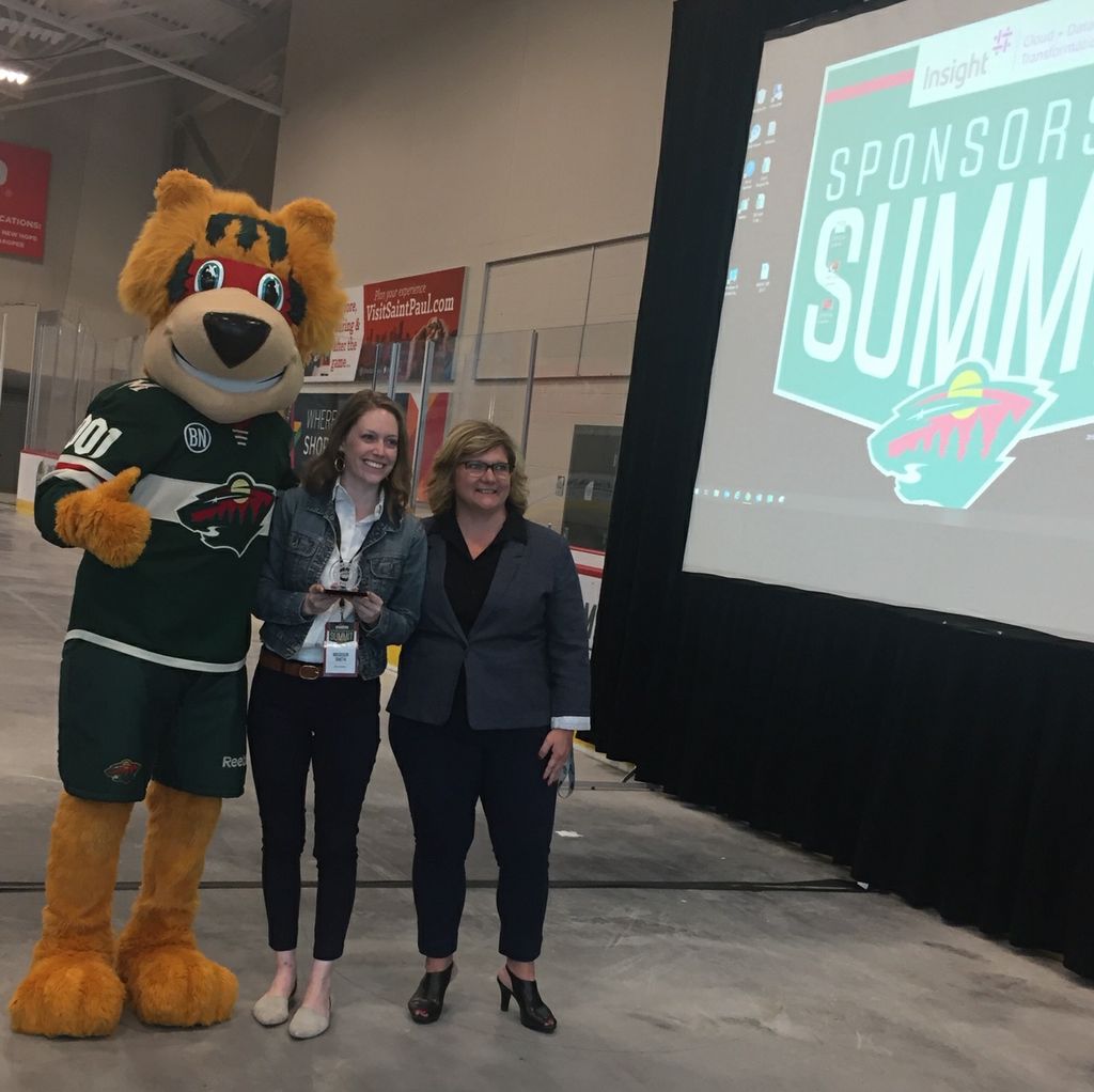 Madison Smith, experiential marketing senior specialist, Associated Bank (center), attended the Minnesota Wild Sponsorship Summit event and accepted the award on the Into the Wild planning team’s behalf.