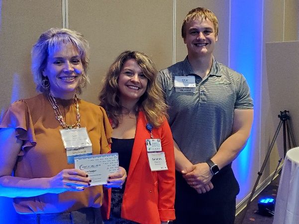 Teuchert (left) attended the event with Sam Diedrich, wellness coordinator and Arthur Valentine, well-being program manager.