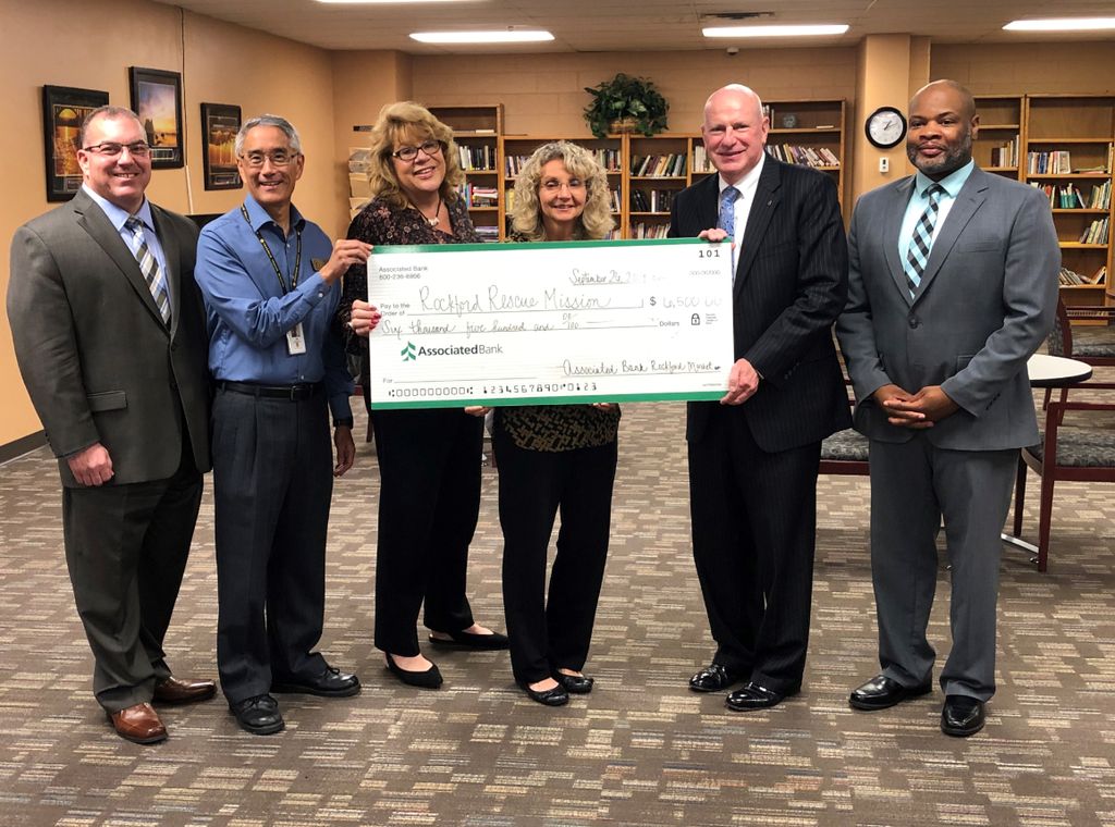 Christopher McFadden, senior bank manager (far right,) and Thomas Kress, Rockford market president (second from right), presented a check to Rockford Rescue Mission.