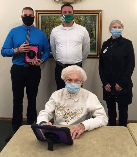Left to right: Bret Kuether, senior bank manager and Mathew Martell, residential loan officer with Associated Bank, and Renee Thompson with Carol, a Felician Village resident.