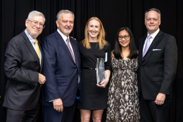 Amy Rach (center), health promotion and well-being specialist, Associated Bank , accepts the Mattingly Workplace Award