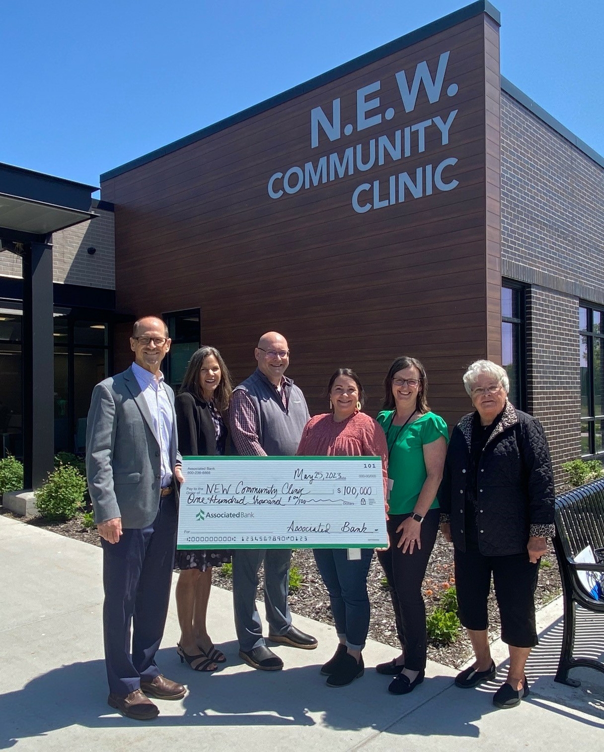 Dennis DeLoye (from left), Angie DeWitt and Bill Kopka with Associated Bank, along with Dr. Katie Patterson, Kim Franzen and board chair Heidi Selberg with N.E.W. Community Clinic