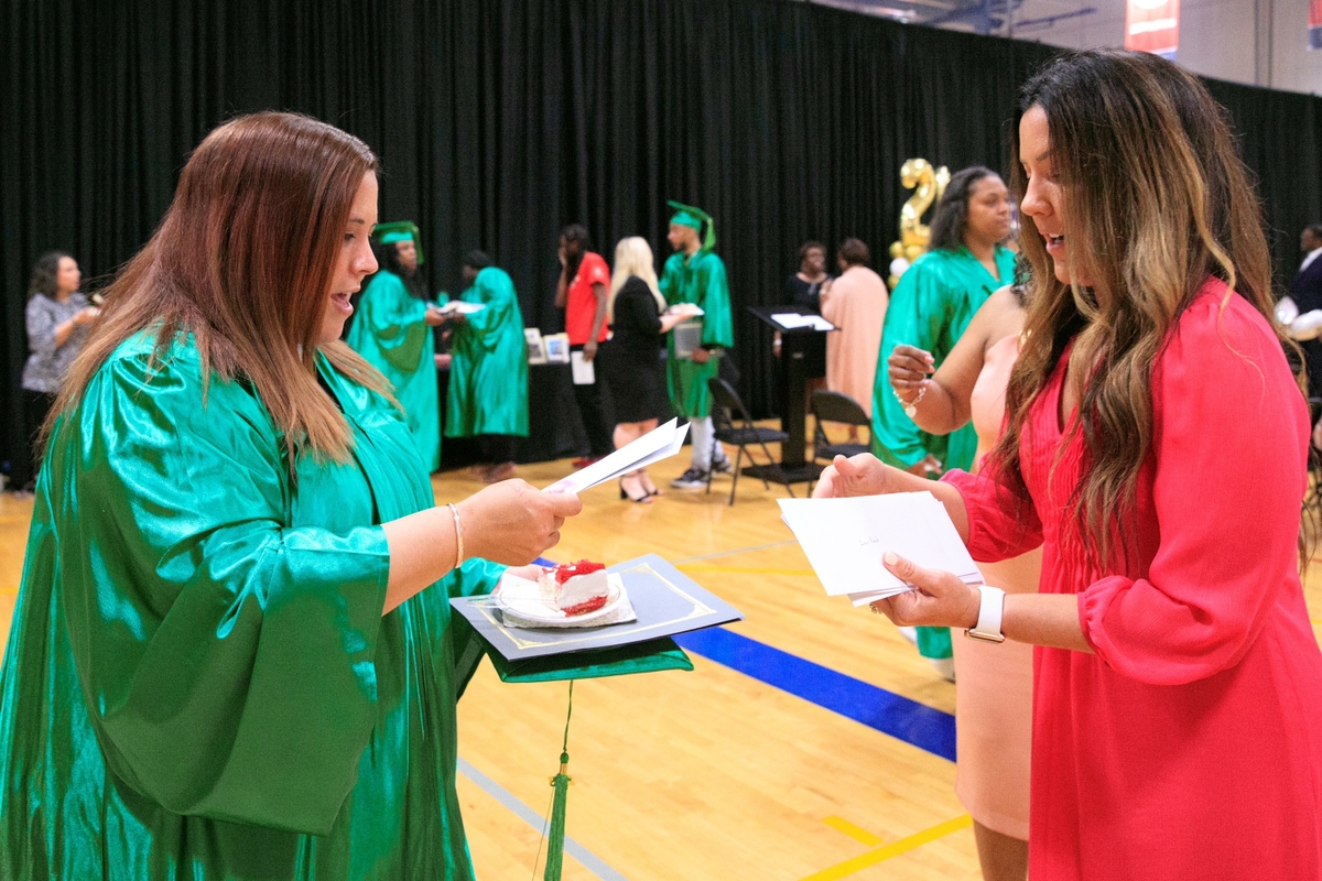 A student is congratulated by Tracy Session of Associated Bank