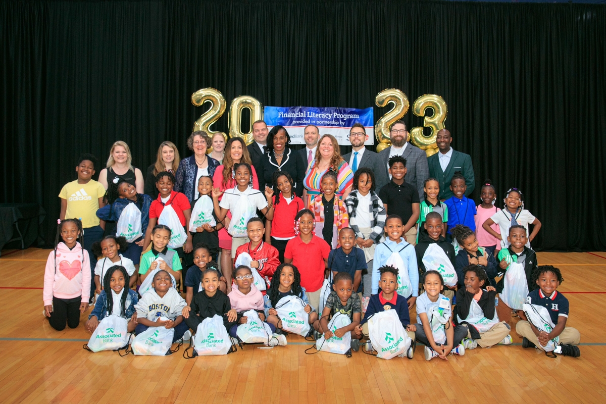 The JJK Academy Kids and SIUE Head Start Kids with food and goody bags from Associated Bank volunteers. 