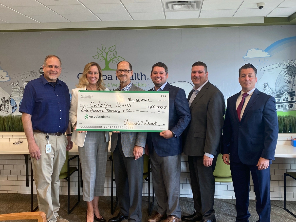 Scott Radtke (from left) and Tracy Guiou with Catalpa Health, along with Dennis DeLoye, Paul Beck, Shawn Carey and Shawn Neuman with Associated Bank