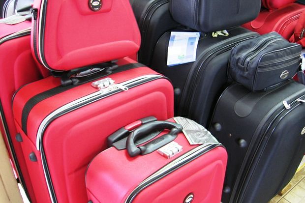 red black luggage piled