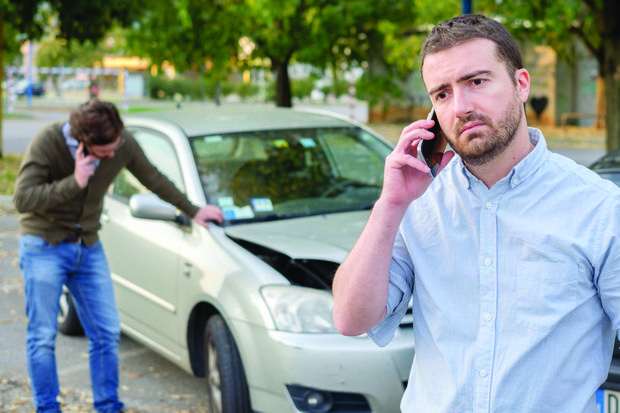 Man on phone after car accident
