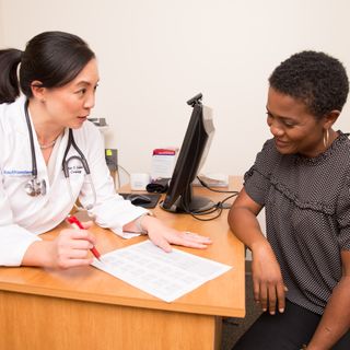 Physician discussing&nbsp;blood pressure measurements with&nbsp;female patient at UTSW Medical Center in Dallas, Texascopyright American Heart Association
