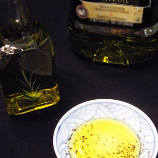 Olive oil in a small bowl with bottlecopyright American Heart Association