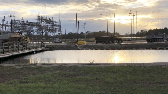 Moving material to construct an access road to reach the primary breaches on the Sutton Lake dam. Photo uploaded Sept. 24, 2018