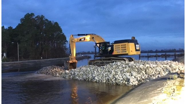Duke Energy constructing a dike to slow the flow of water out of the Sutton Lake overnight. Photo uploaded Sept. 25, 2018.