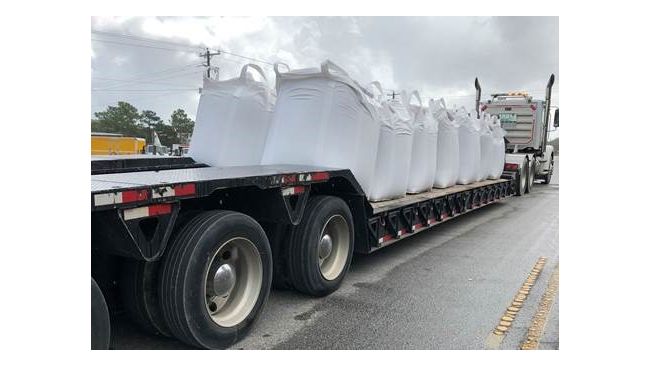 Large sandbags ready to be used to help stop the flow of water out of breached in the Sutton Lake dam. Photo uploaded Sept. 26, 2018.