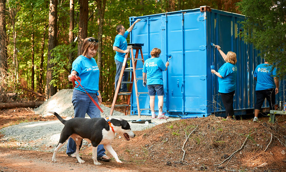 Volunteers help walk dogs at a nonprofit animal adoption agency in South Carolina.