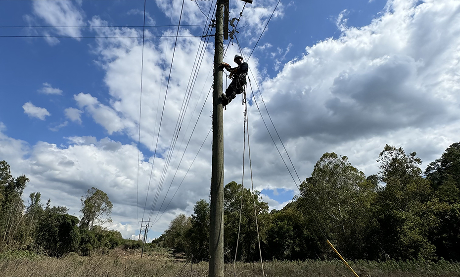 Martinka works atop a distribution pole as he helps get power restored to the VA hospital in Asheville.
