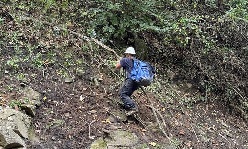 Lineworker Matt Martinka strapped supplies to his back and hiked through flood-damaged terrain to reach the VA hospital