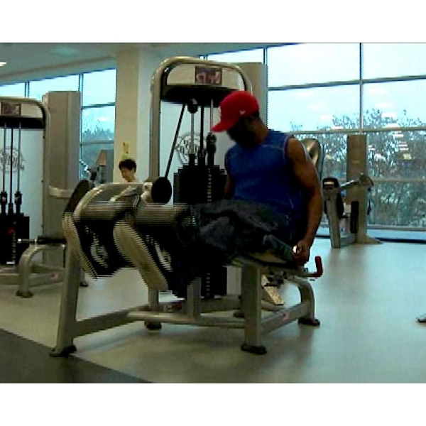 man+working+out+on+leg+weights