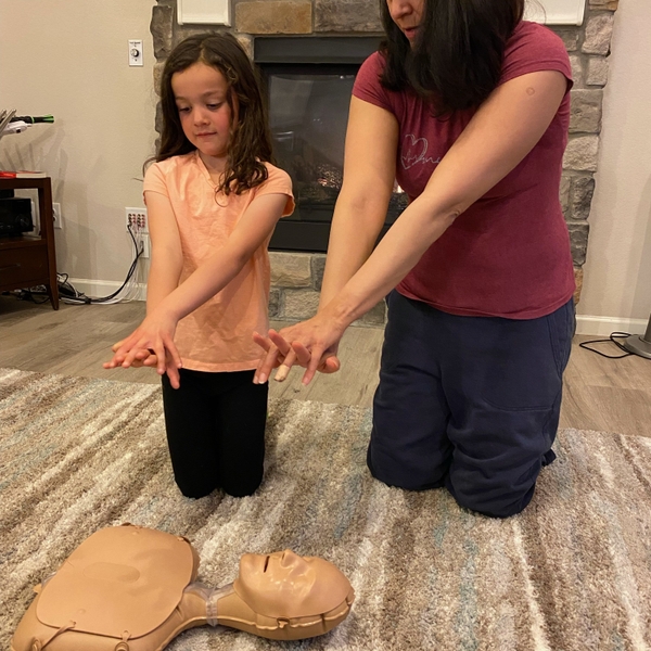 Mom+showing+daughter+proper+CPR+form+