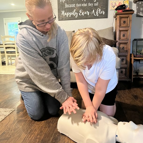 woman+showing+child+CPR+technique