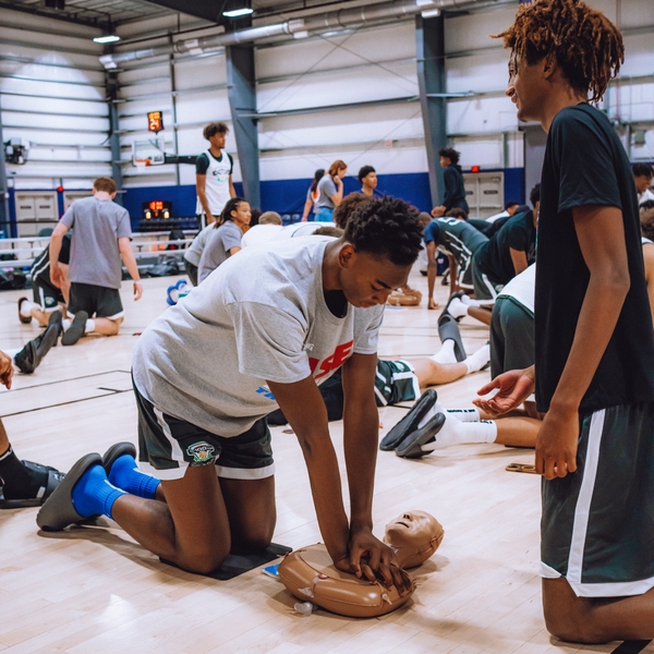 athlete+practicing+CPR