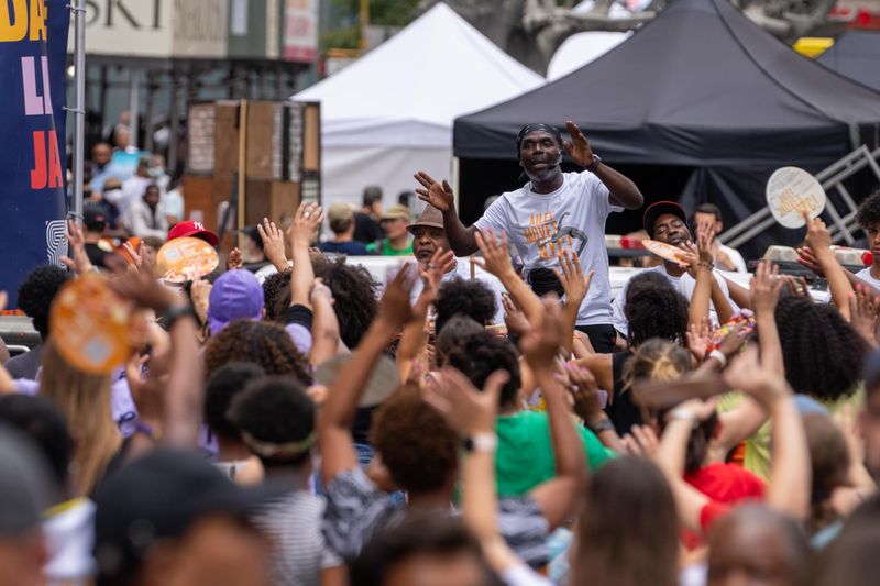Ailey Extension's Maguette Camara leading West African in Times Square, Ailey Moves NYC 2022
