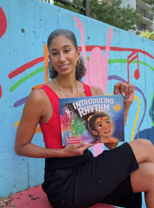 Alicia Graf Mack with her book, Introducing Rhythm